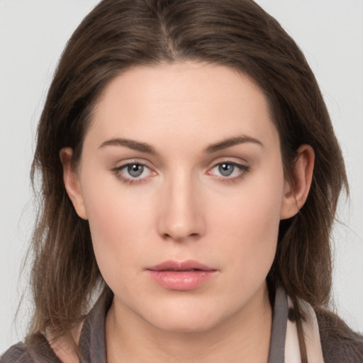 Neutral white young-adult female with long  brown hair and brown eyes