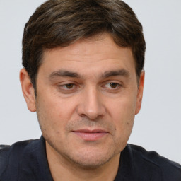 Joyful white adult male with short  brown hair and brown eyes