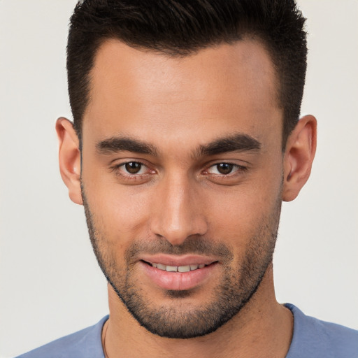 Joyful white young-adult male with short  brown hair and brown eyes