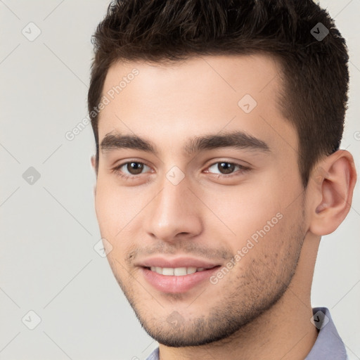 Joyful white young-adult male with short  brown hair and brown eyes