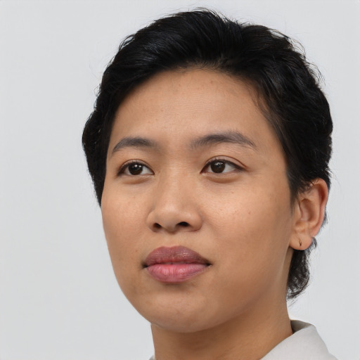Joyful asian young-adult female with short  black hair and brown eyes