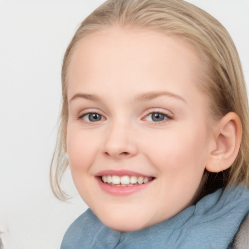 Joyful white child female with medium  brown hair and blue eyes