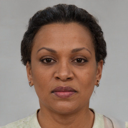 Joyful latino adult female with short  brown hair and brown eyes