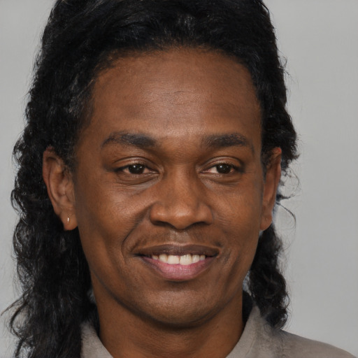 Joyful black adult male with medium  black hair and brown eyes