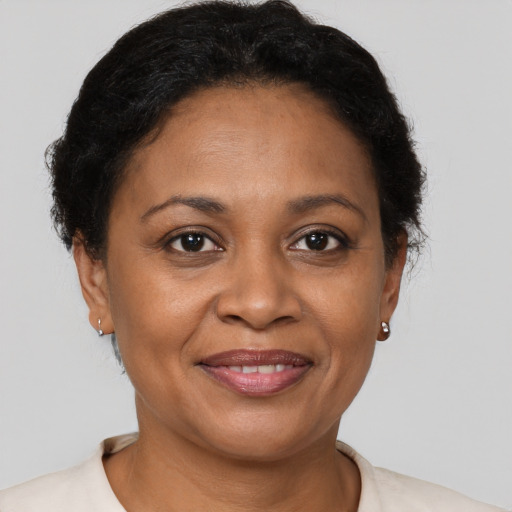 Joyful black adult female with short  brown hair and brown eyes