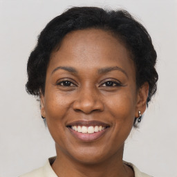 Joyful black adult female with short  brown hair and brown eyes