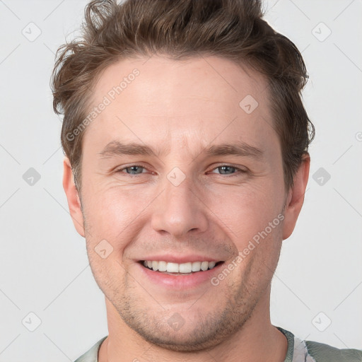 Joyful white adult male with short  brown hair and grey eyes