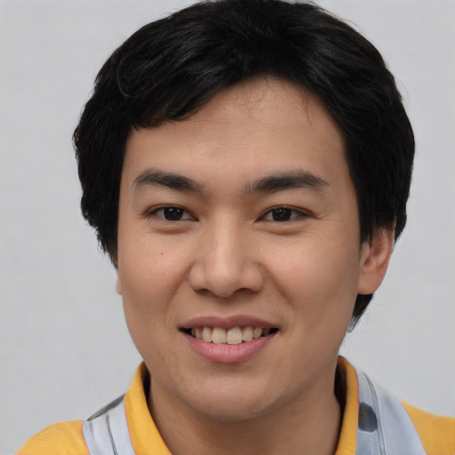 Joyful asian young-adult male with short  brown hair and brown eyes