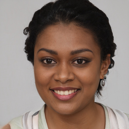 Joyful black young-adult female with medium  black hair and brown eyes