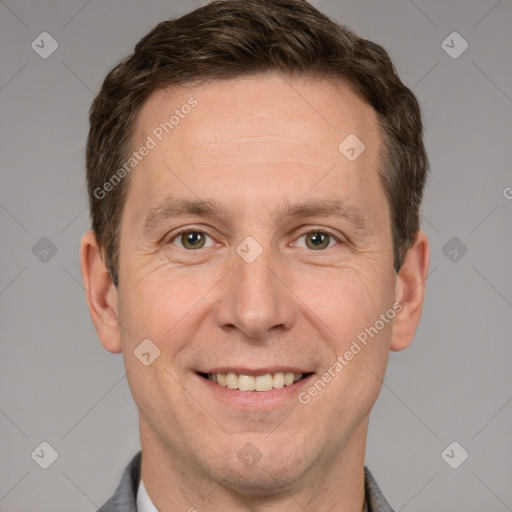 Joyful white adult male with short  brown hair and grey eyes