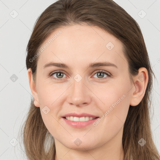 Joyful white young-adult female with long  brown hair and grey eyes