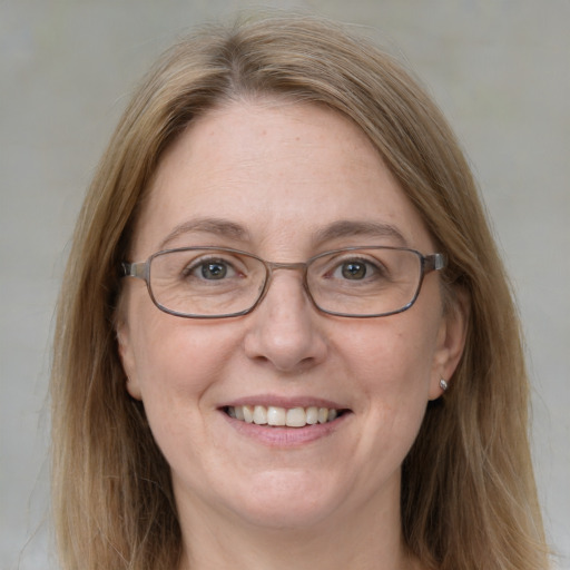 Joyful white adult female with medium  brown hair and blue eyes