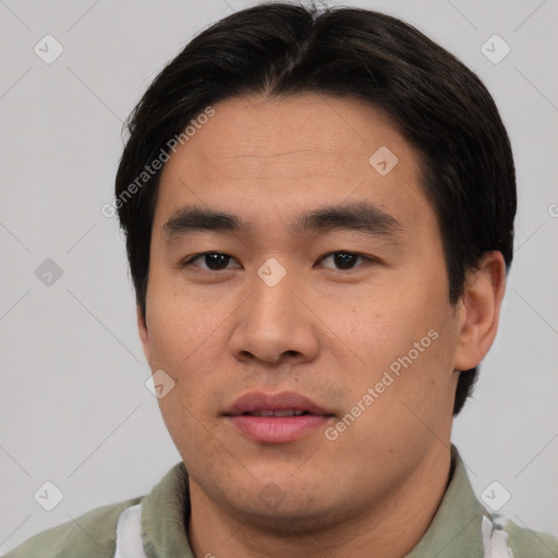 Joyful asian young-adult male with short  black hair and brown eyes