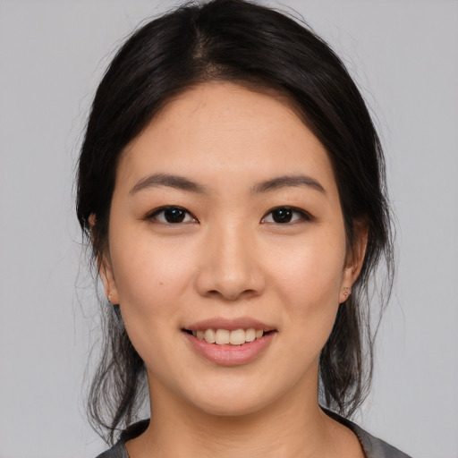 Joyful asian young-adult female with medium  black hair and brown eyes