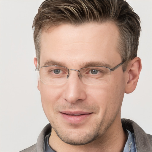 Joyful white adult male with short  brown hair and grey eyes