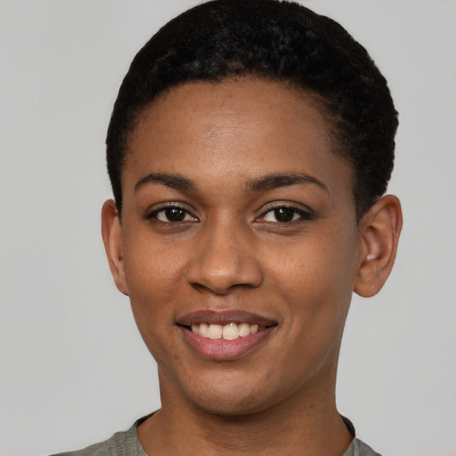 Joyful black young-adult female with short  black hair and brown eyes