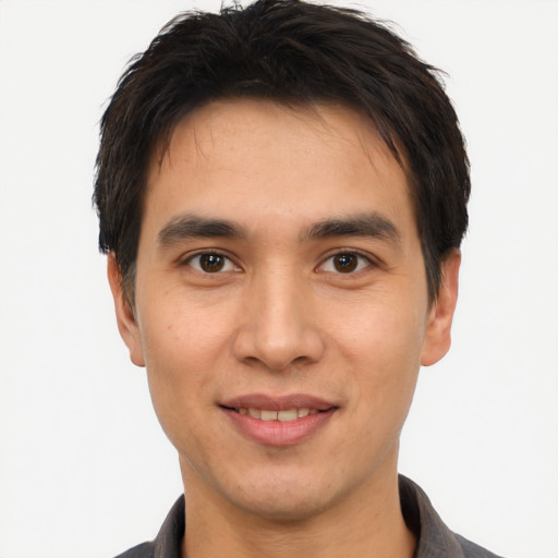 Joyful asian young-adult male with short  brown hair and brown eyes