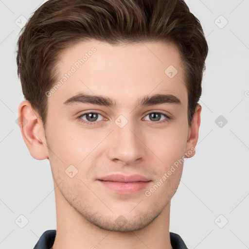 Joyful white young-adult male with short  brown hair and grey eyes