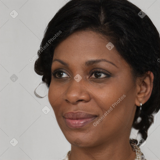 Joyful black young-adult female with medium  brown hair and brown eyes