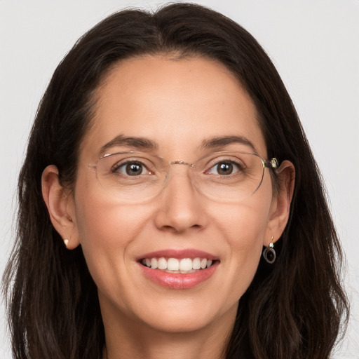 Joyful white adult female with long  brown hair and brown eyes