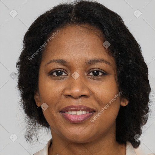 Joyful black adult female with medium  brown hair and brown eyes