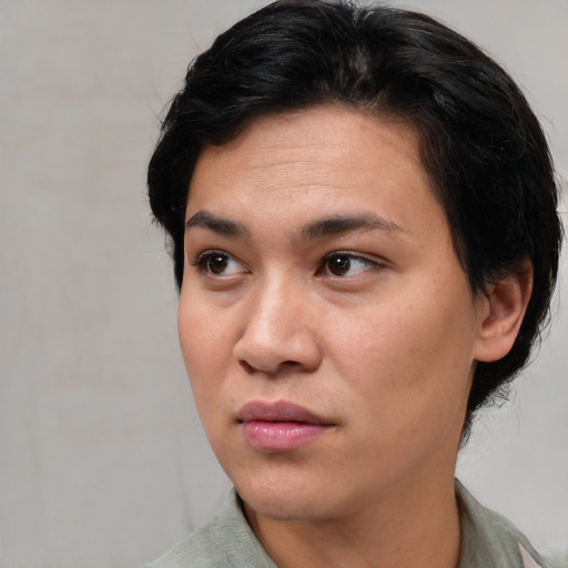 Joyful asian young-adult female with short  black hair and brown eyes