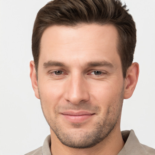 Joyful white young-adult male with short  brown hair and brown eyes