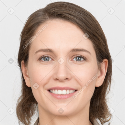 Joyful white young-adult female with medium  brown hair and grey eyes