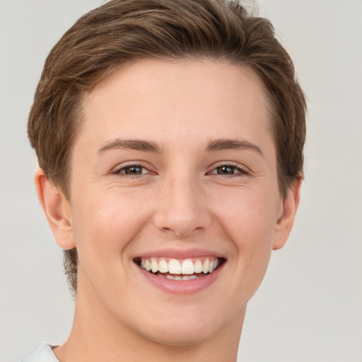 Joyful white young-adult female with short  brown hair and grey eyes