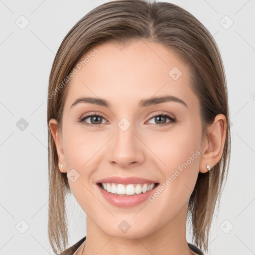 Joyful white young-adult female with long  brown hair and grey eyes