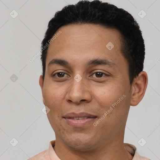 Joyful white young-adult male with short  black hair and brown eyes