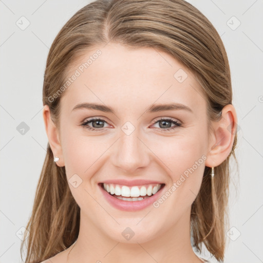 Joyful white young-adult female with medium  brown hair and green eyes