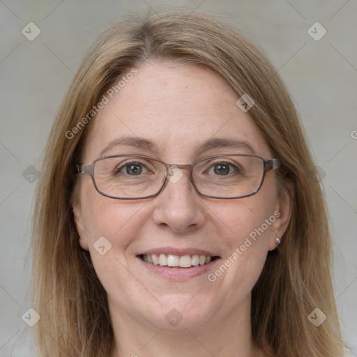 Joyful white adult female with medium  brown hair and blue eyes