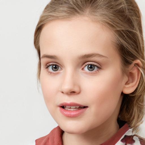 Joyful white child female with medium  brown hair and blue eyes