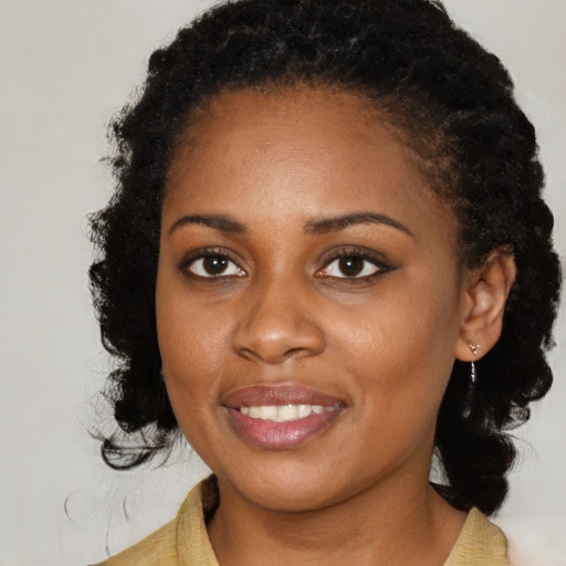 Joyful black young-adult female with medium  black hair and brown eyes