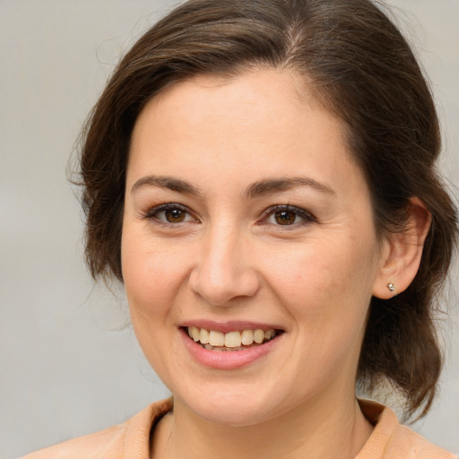 Joyful white young-adult female with medium  brown hair and brown eyes