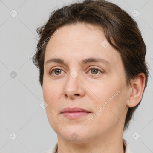 Joyful white adult female with short  brown hair and brown eyes