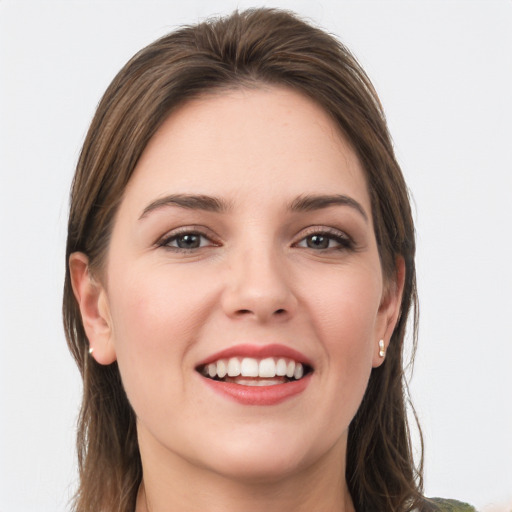 Joyful white young-adult female with long  brown hair and grey eyes