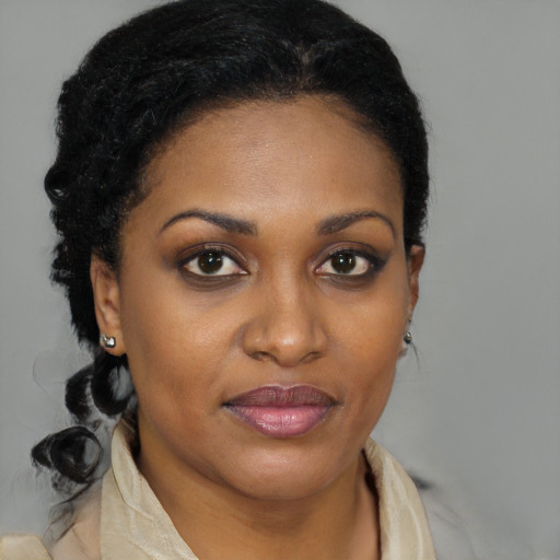 Joyful black young-adult female with medium  brown hair and brown eyes