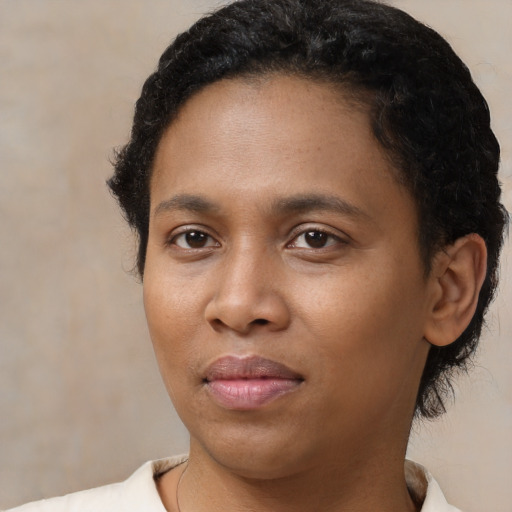 Joyful black young-adult female with short  black hair and brown eyes
