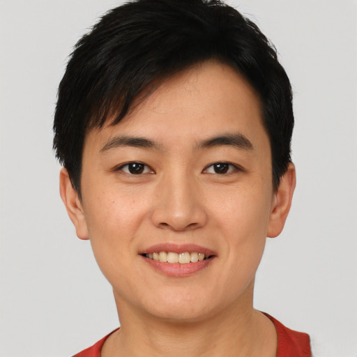 Joyful asian young-adult female with short  black hair and brown eyes