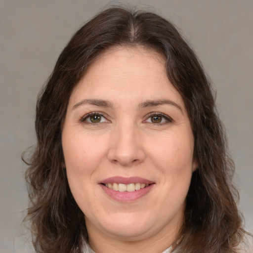 Joyful white adult female with medium  brown hair and brown eyes