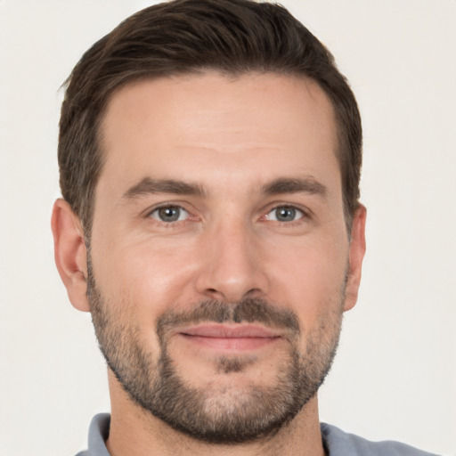 Joyful white adult male with short  brown hair and brown eyes