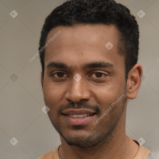 Joyful black young-adult male with short  black hair and brown eyes