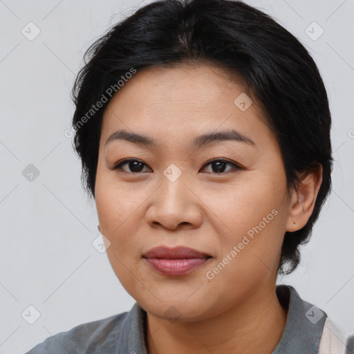 Joyful asian young-adult female with medium  black hair and brown eyes