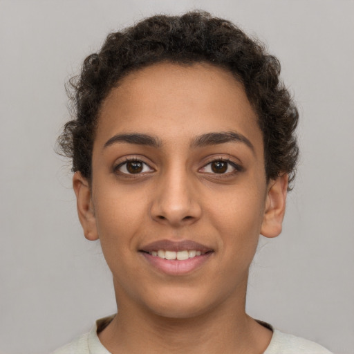 Joyful latino young-adult female with short  brown hair and brown eyes