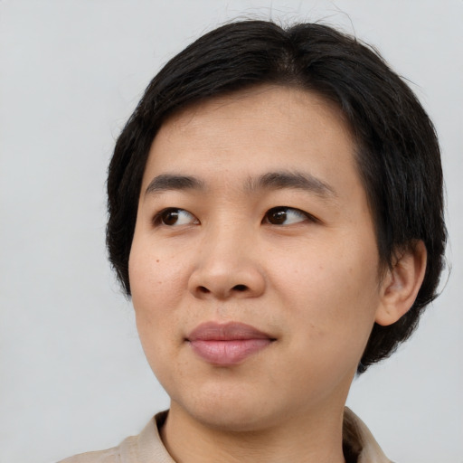 Joyful asian young-adult male with short  black hair and brown eyes