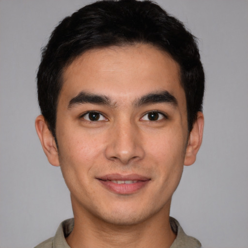 Joyful latino young-adult male with short  brown hair and brown eyes