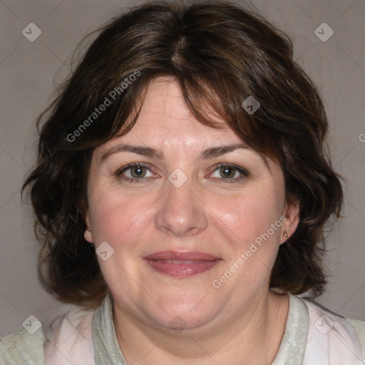 Joyful white adult female with medium  brown hair and blue eyes