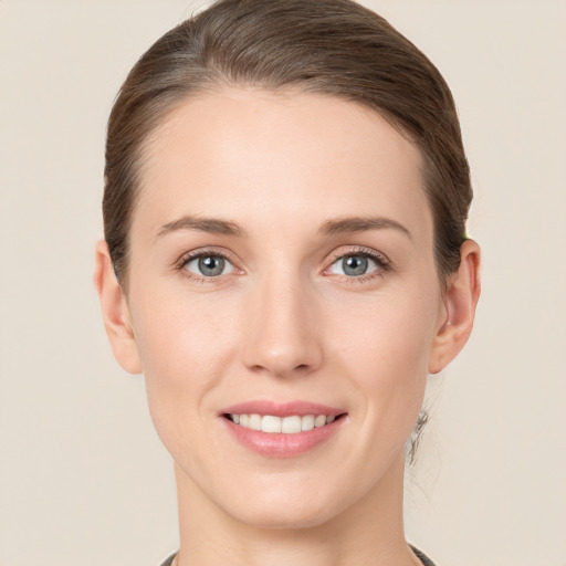 Joyful white young-adult female with short  brown hair and grey eyes